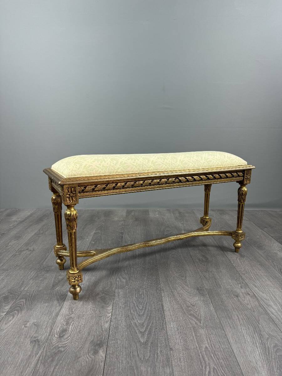 Antique gilded wooden bench in Louis XVI style, 19th century.