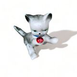 Little ceramic cat playing with a playful ladybug plays gray and white decoration