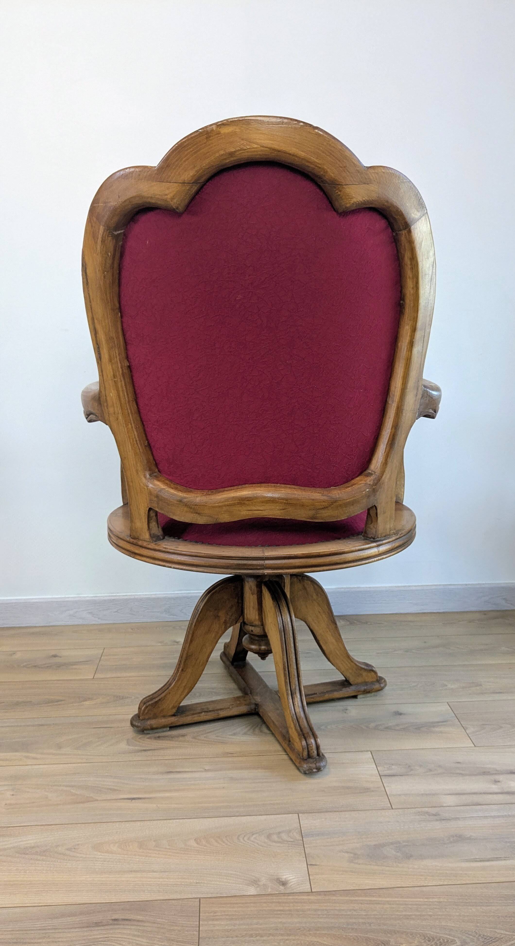 Vintage captain's chair in wood and garnet fabric — a seat with character