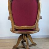Vintage captain's chair in wood and garnet fabric — a seat with character