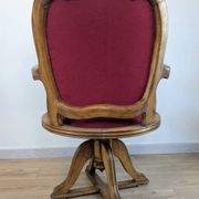 Vintage captain's chair in wood and garnet fabric — a seat with character