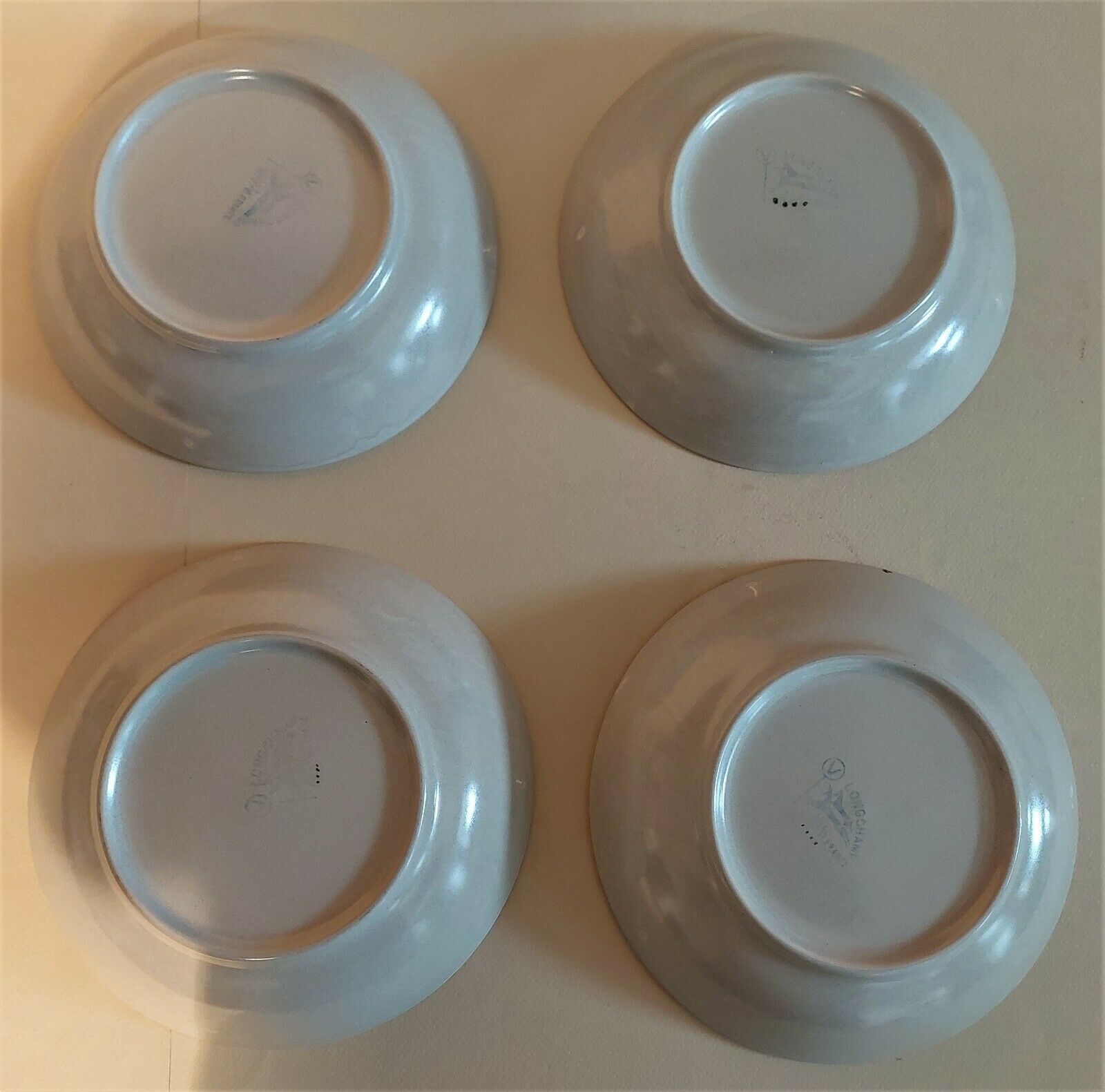 Vintage hollow plates in sandstone series of four marked Longchamp