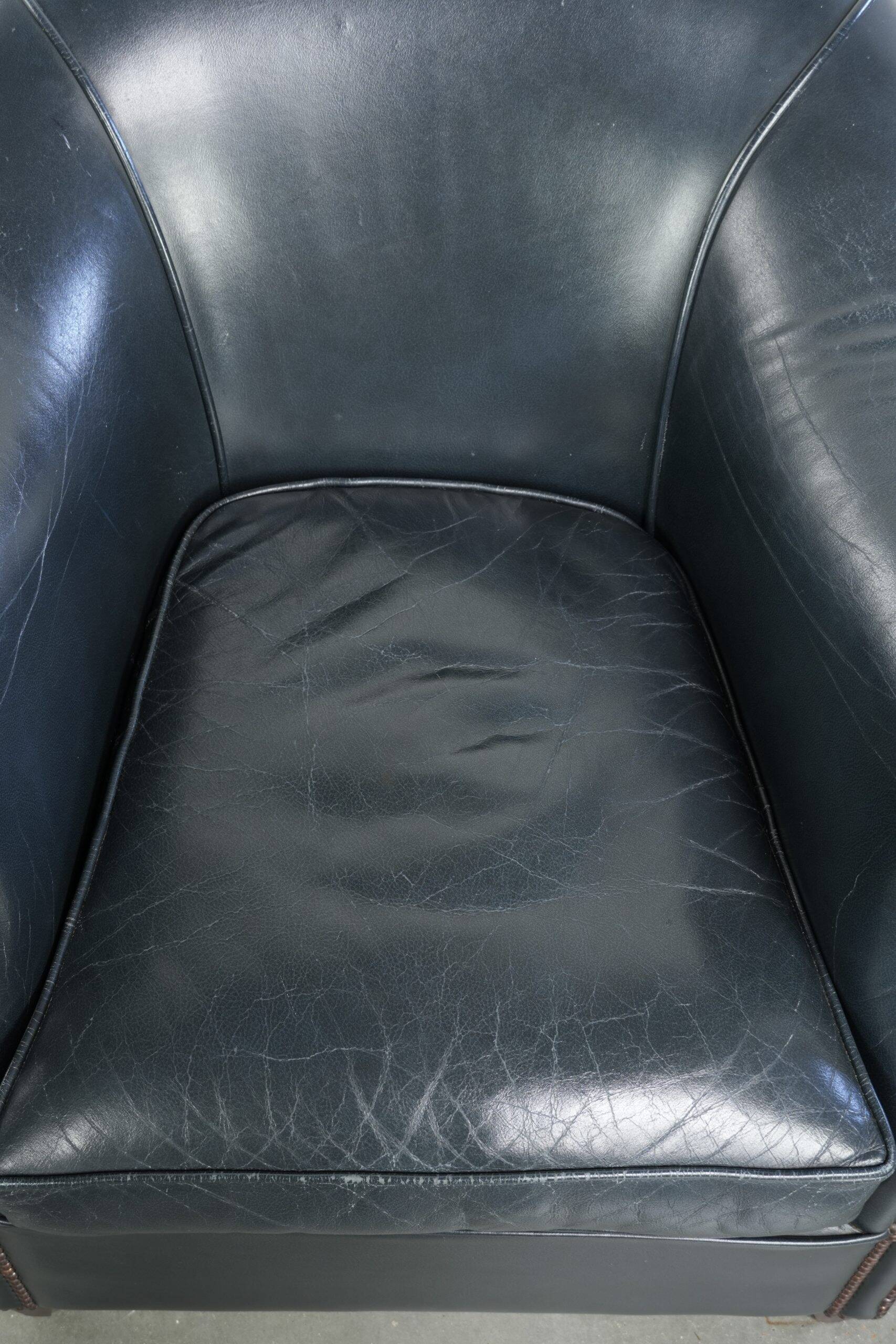 Dark blue cowhide club armchair with a unique and timeless design