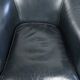 Dark blue cowhide club armchair with a unique and timeless design