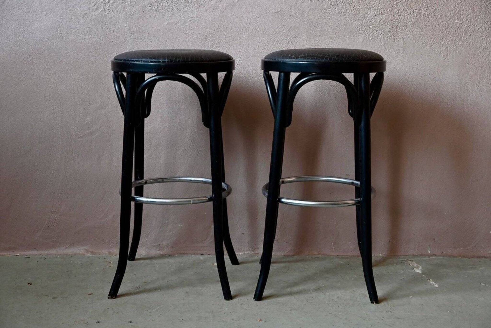 Pair of 1960s bistro bar stools in black and chrome with vinyl shell.