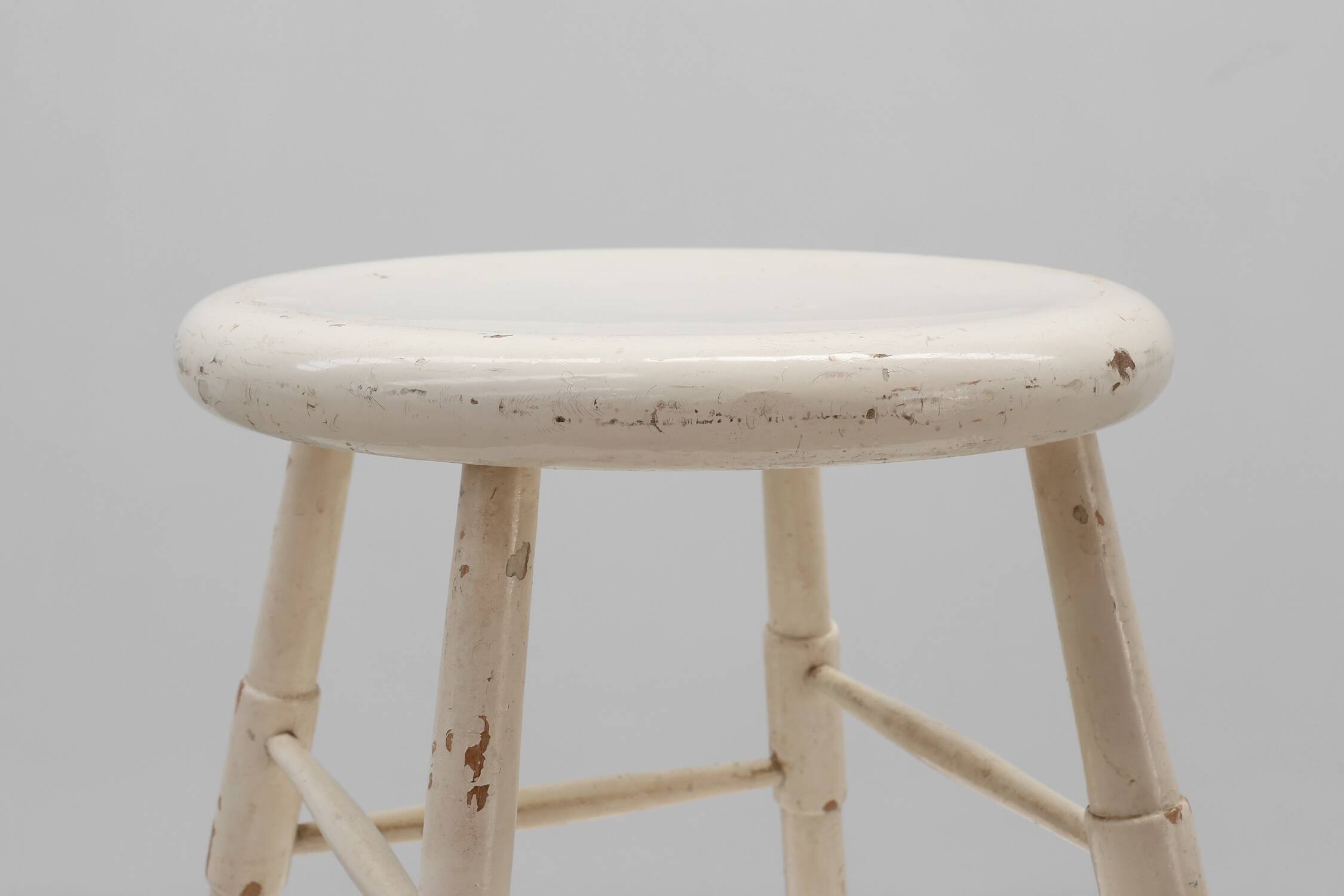 Rustic white wooden low farm stool, France ca. 1920