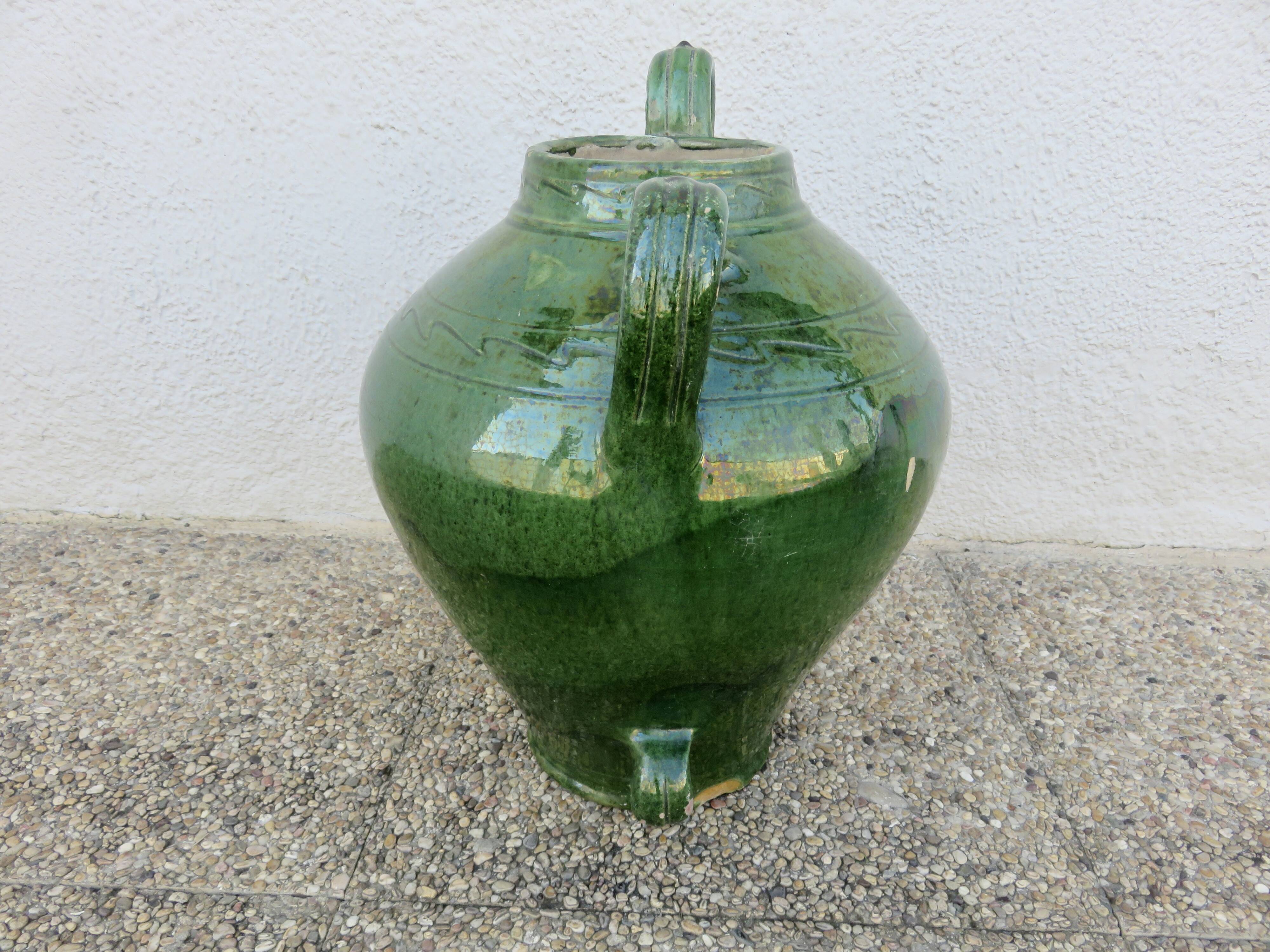 Antique glazed green terracotta oil jar, late 19th century.