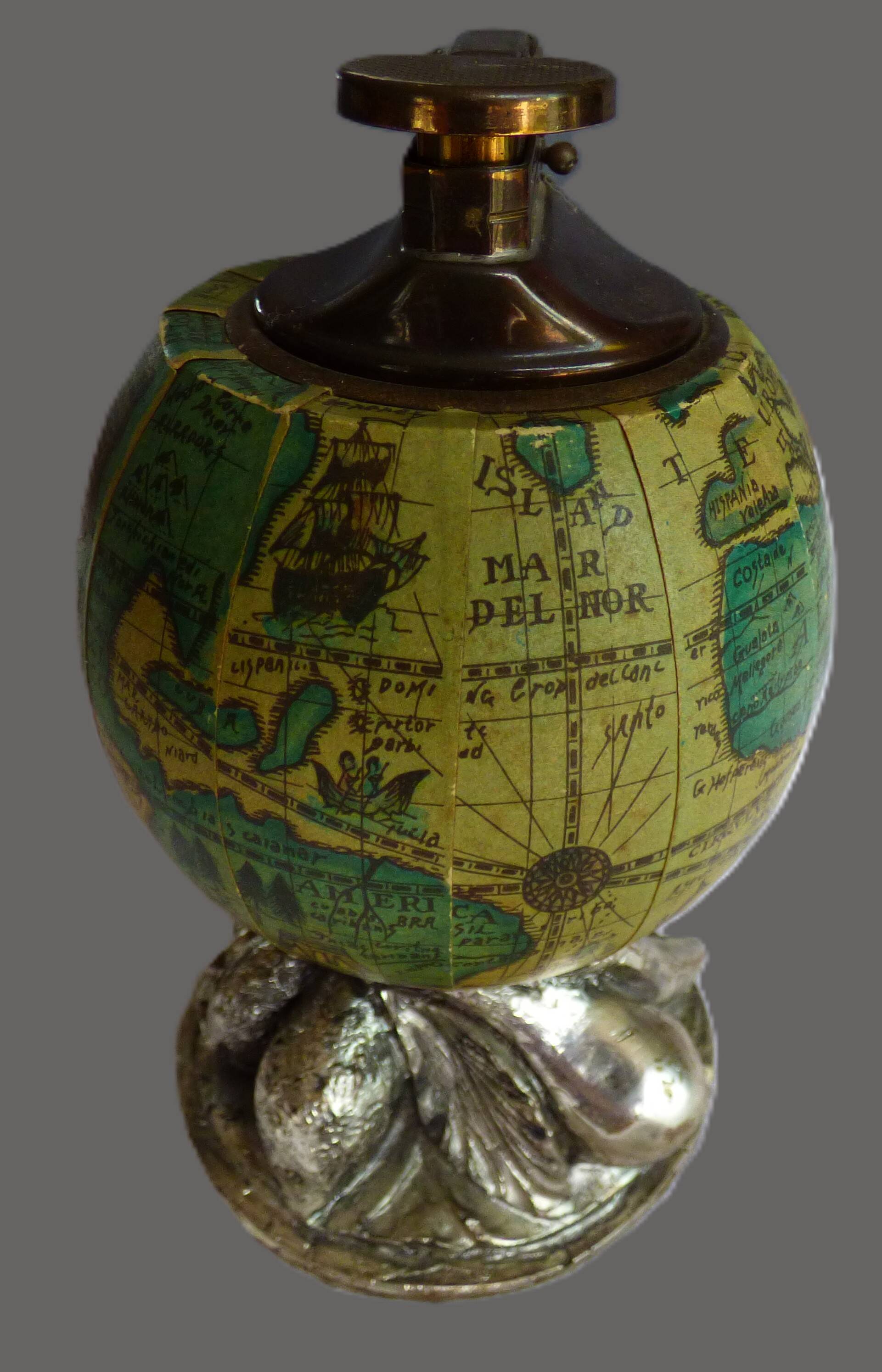 Vintage antique lighter with a globe and silver-plated stand.