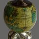 Vintage antique lighter with a globe and silver-plated stand.