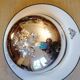 Silver metal bell on its porcelain dish