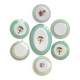 Old mismatched earthenware dinner plates with gold accompanied by a dish