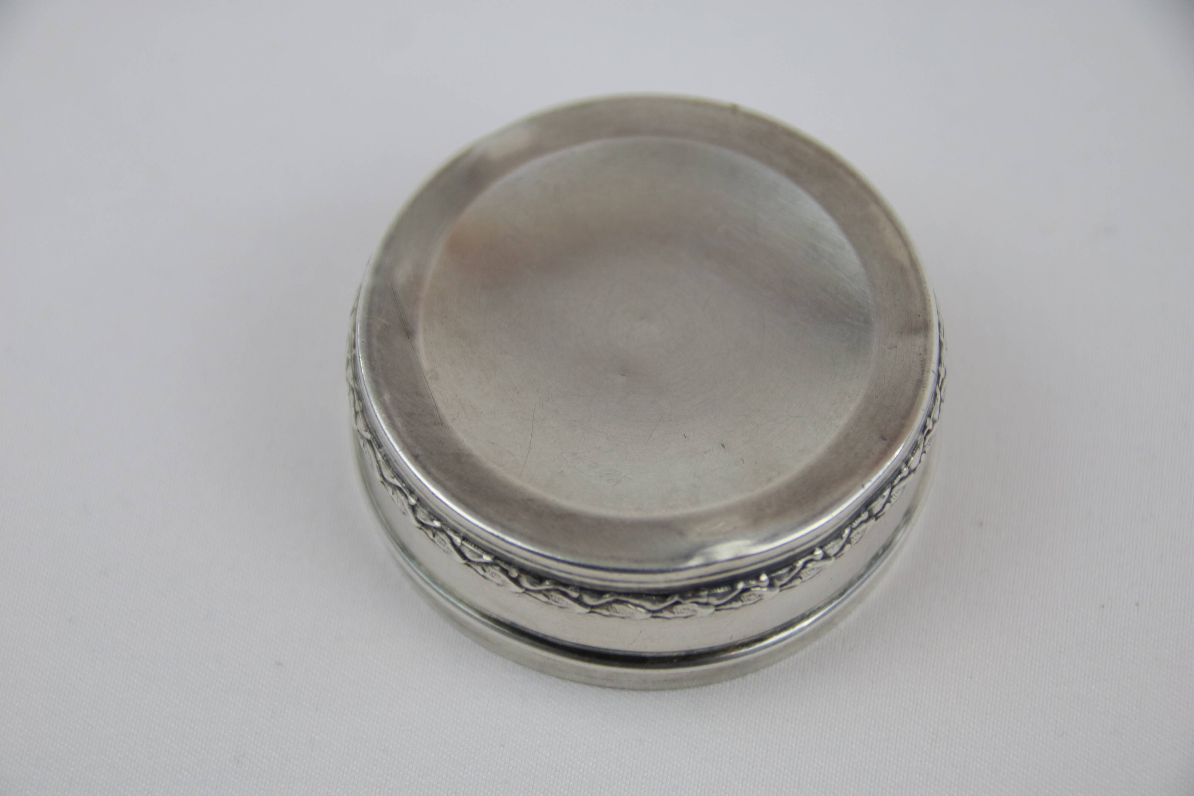 Small round box with silver pills