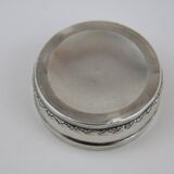 Small round box with silver pills