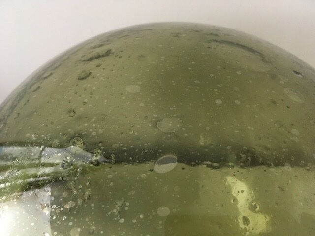 Old demijohn full of bubbles