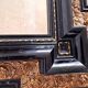 Antique wall mirror in blackened wood and gilded stucco, 19th-century Dutch style.