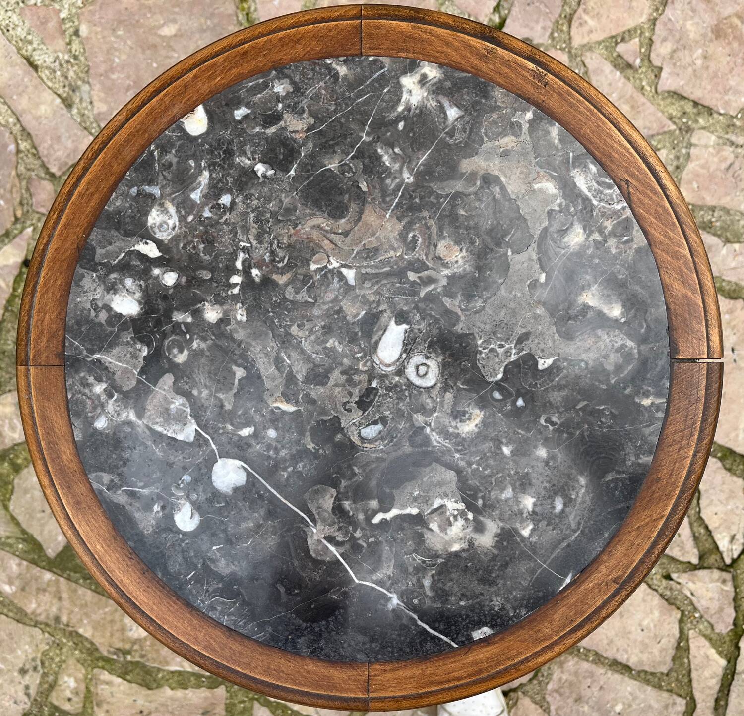 Old wooden pedestal table with marble top