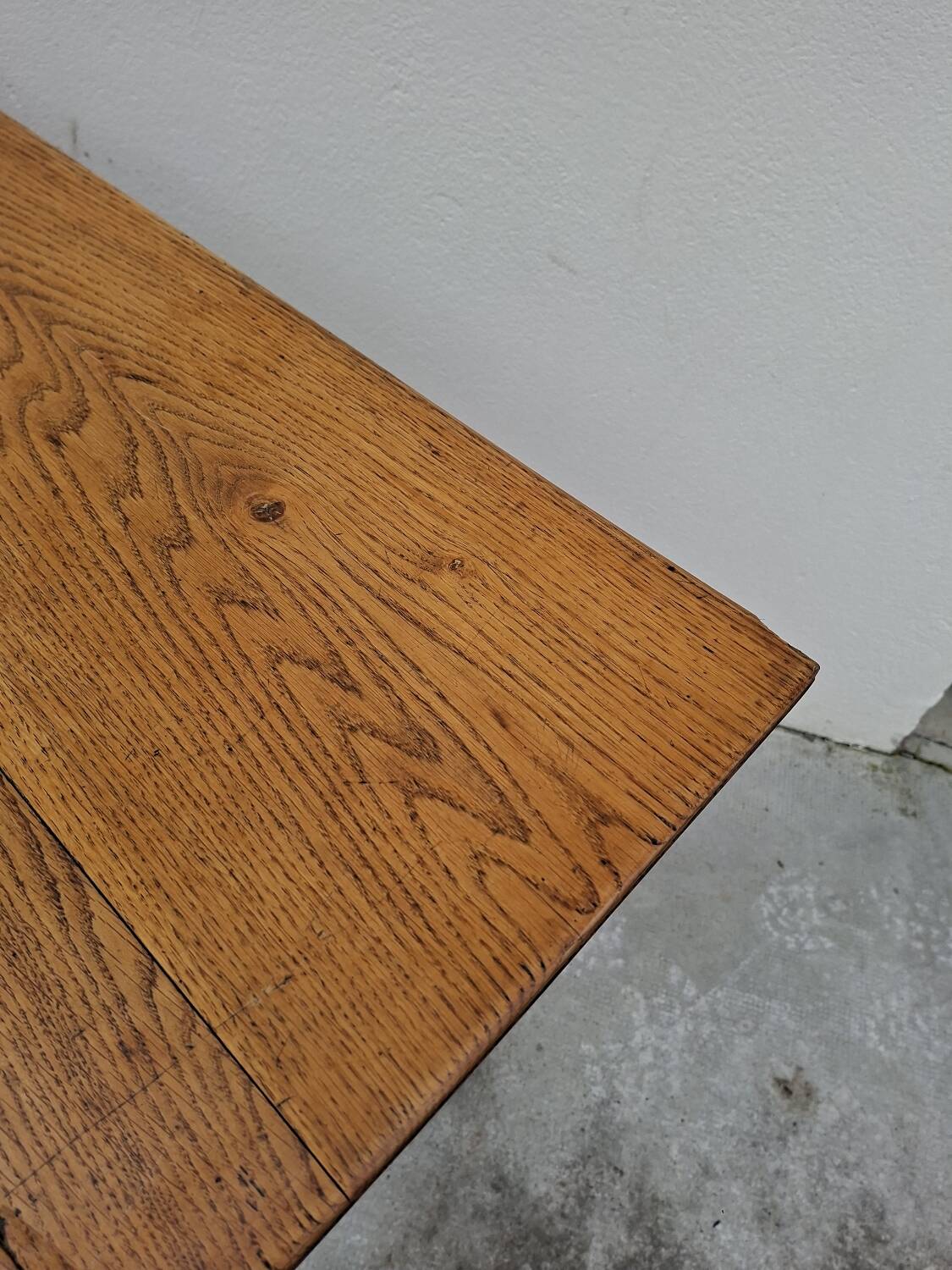 Solid oak bistro table with a cast iron base, signed.