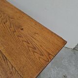 Solid oak bistro table with a cast iron base, signed.