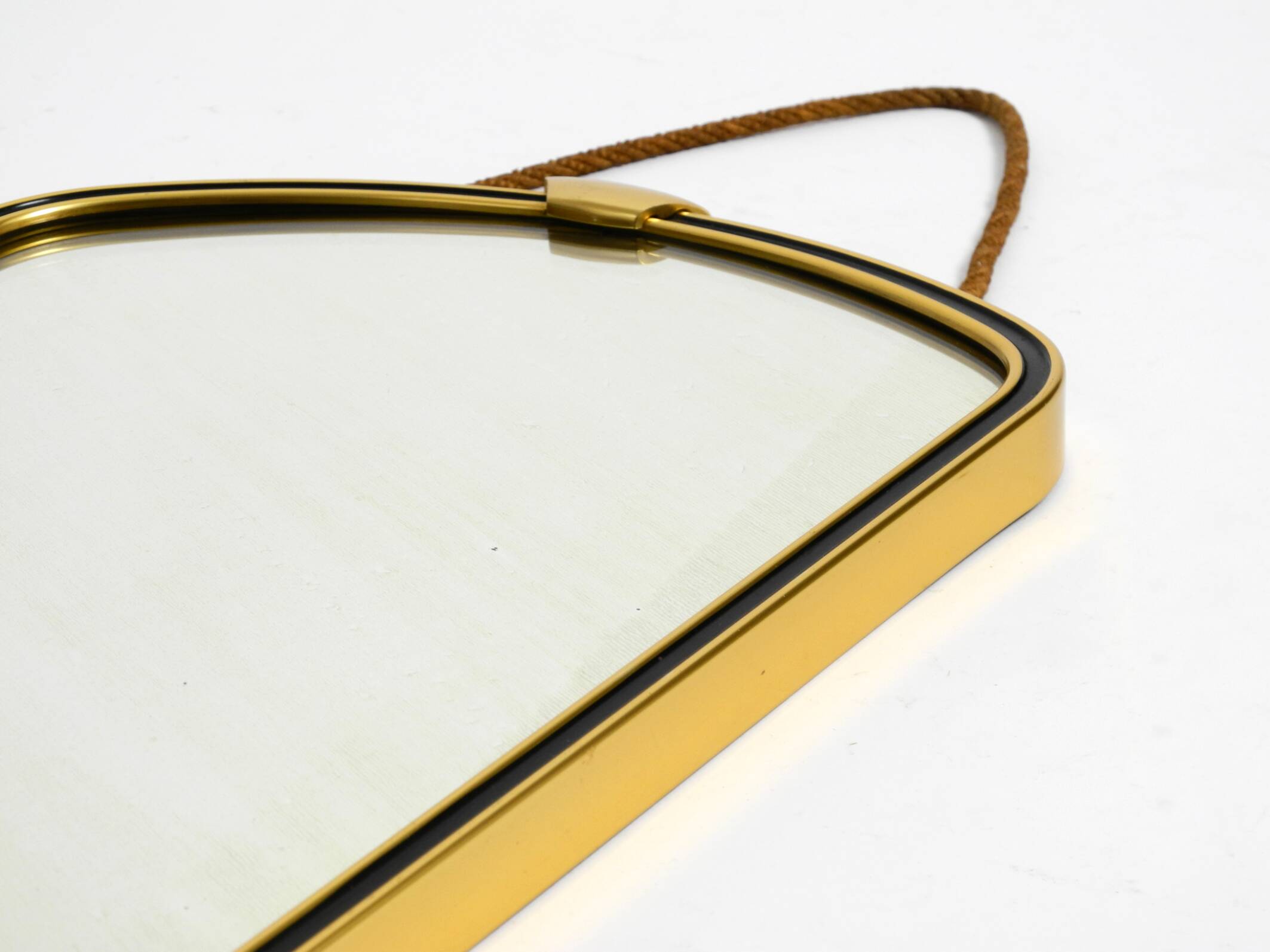Beautiful small mid-century brass wall mirror with braided hanging strap
