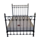 Old bed in black iron and brass