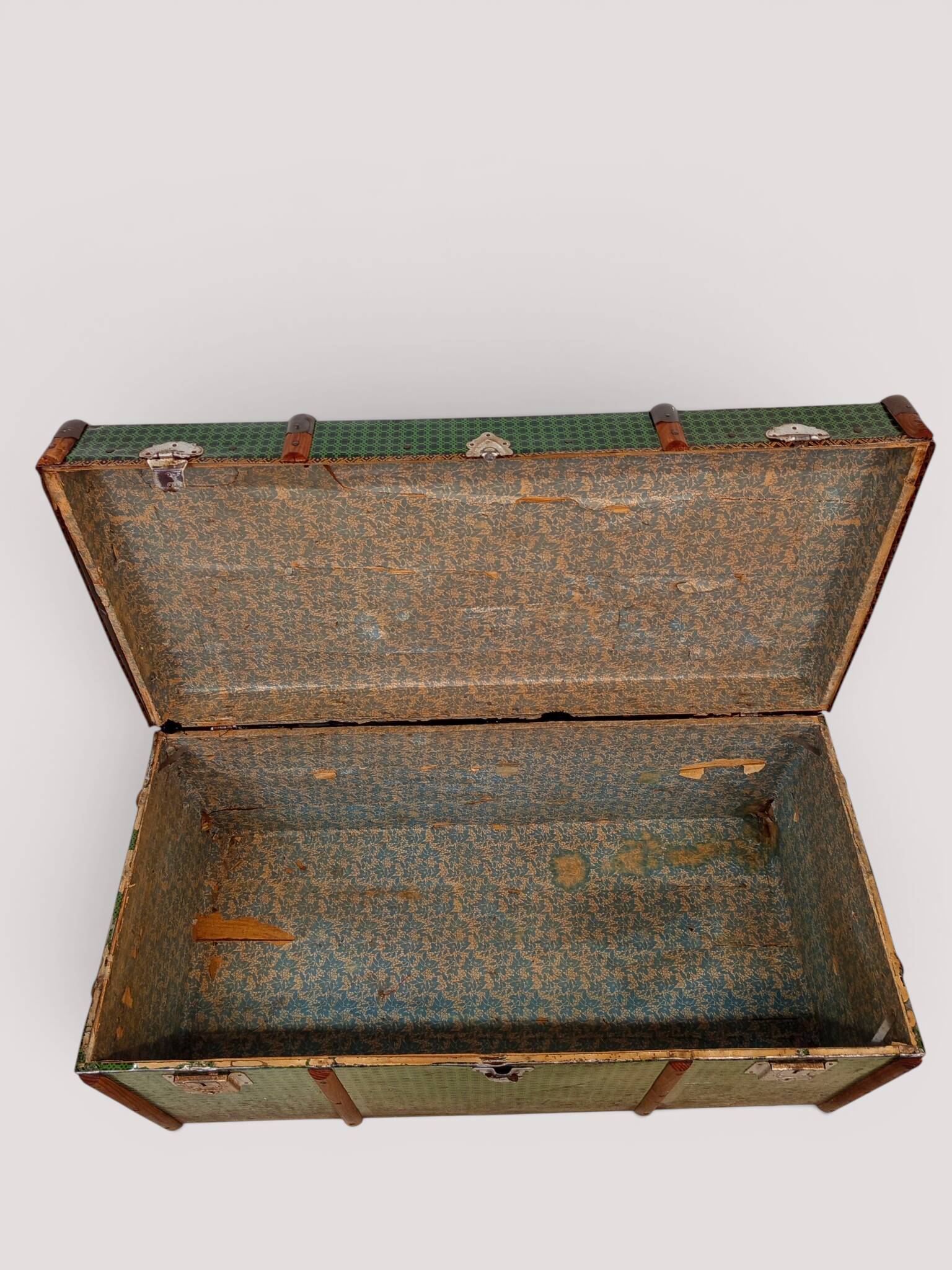 Vintage wooden and metal green travel trunk, circa 1930.
