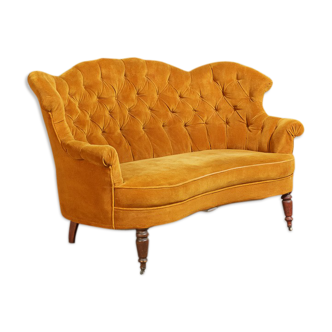 Yellow velvet padded toad sofa and wooden feet
