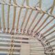 Rattan cradle for doll on vintage wheels