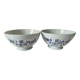 Two vintage farm bowls on a pale blue pedestal with floral decoration.