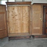 Hungarian wardrobe in carved brown wood from the late 19th century, with 2 doors and a lower drawer.