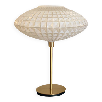 Table lamp with a vintage glass globe and saucer and a golden foot