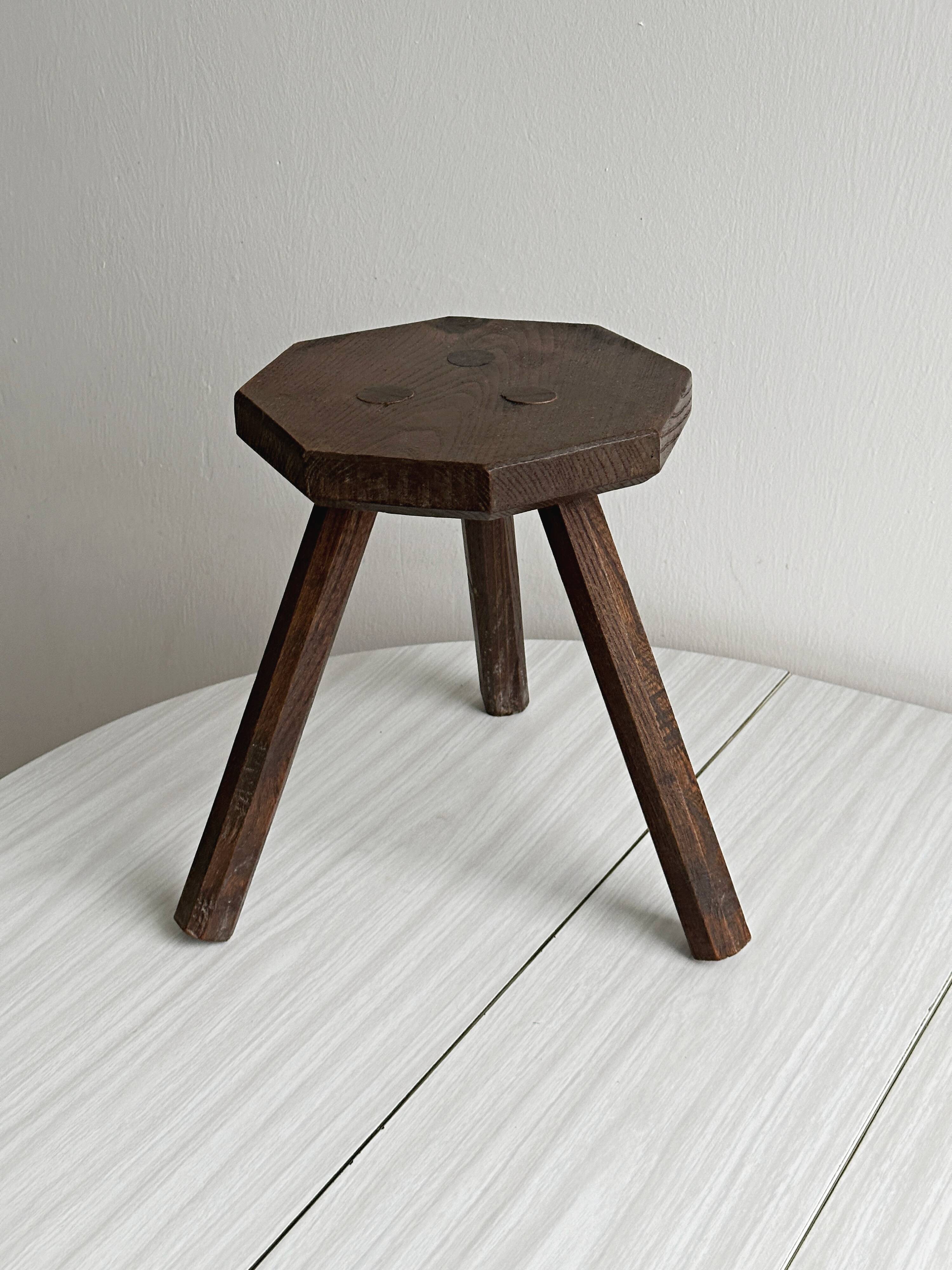 Small dark wooden tripod stool