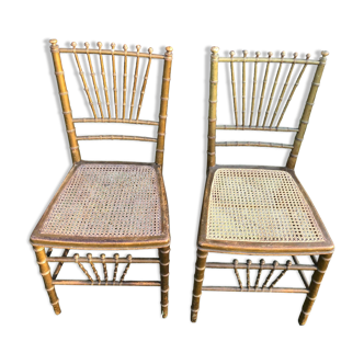 Pair of canned chairs in gilded wood