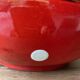 Ceramic salad bowl in red with white polka dots.