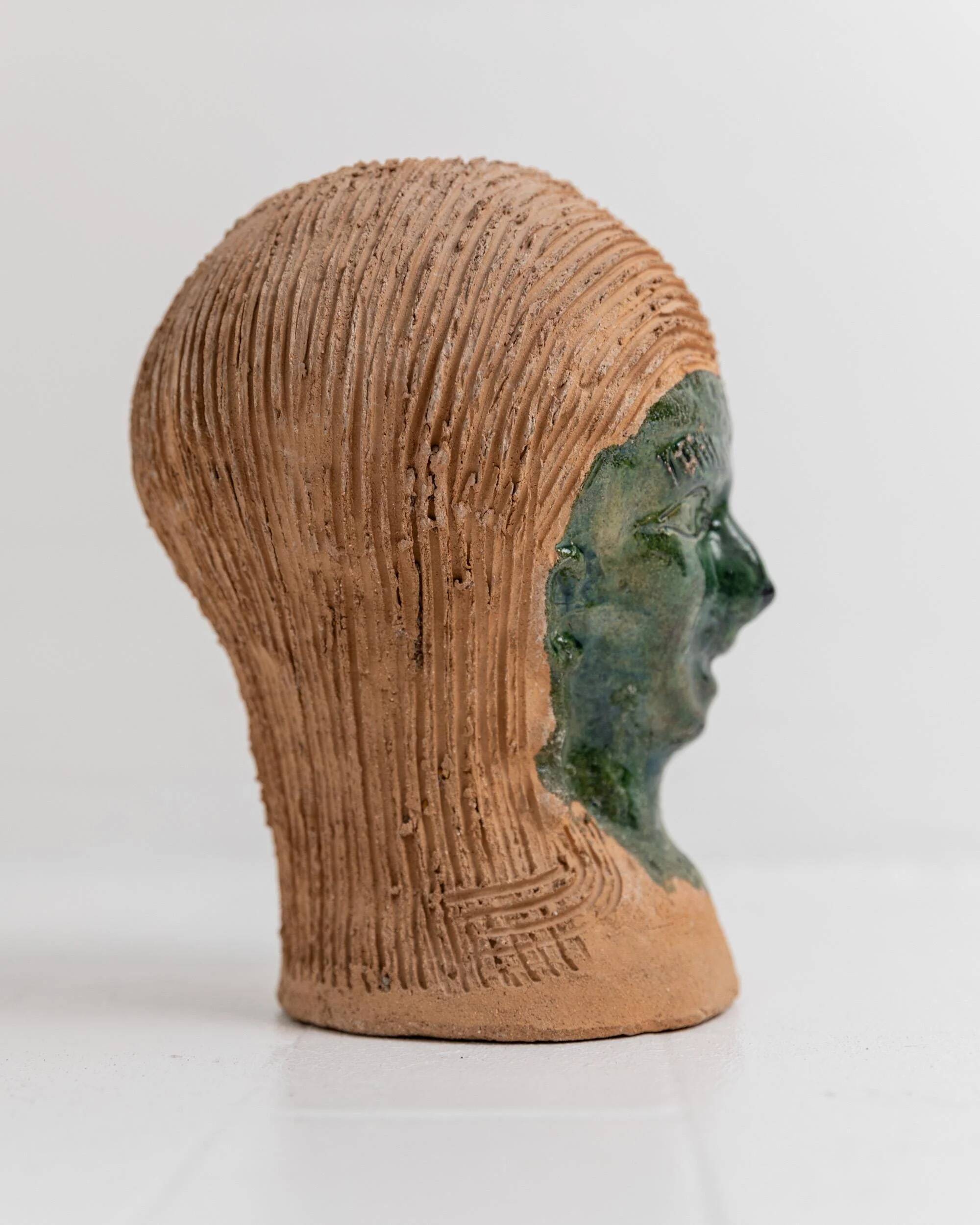 Vintage ceramic vase from the 1980s, sculptural head shape with a green glazed face, terracotta art object.