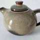 Vintage ceramic teapot with a flame design.
