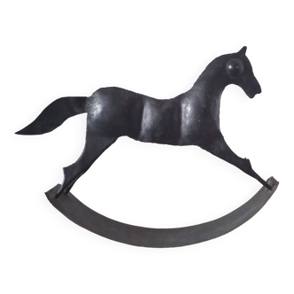 Stylized rocking horse in 60s design sheet metal