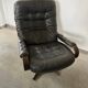 Scandinavian swivel lounge chair in black leather with a bent wood frame, 1970s.