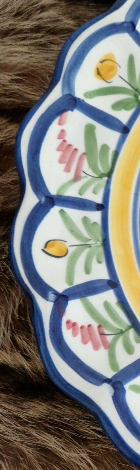 Large hand-painted French faience plate with floral decoration in folk art style.