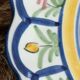 Large hand-painted French faience plate with floral decoration in folk art style.