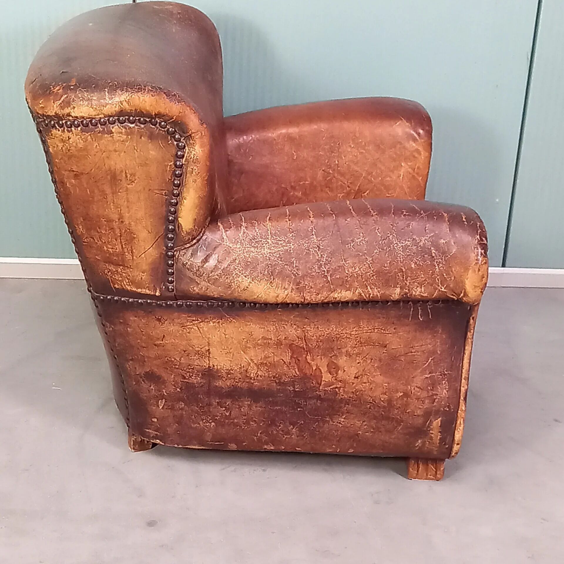Leather nailed armchair
