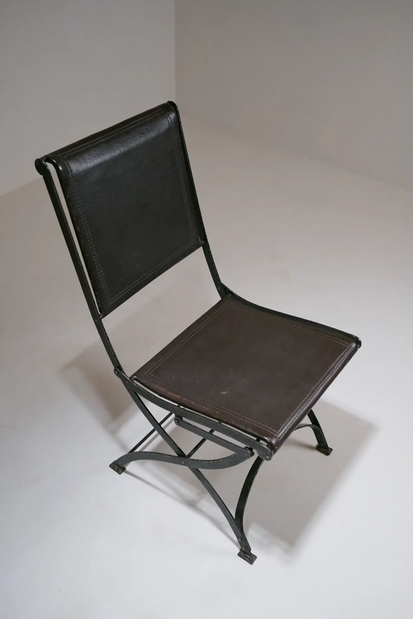 Foldable chair in wrought iron and leather. c. 1950