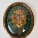 Domed glass frame with its bouquet of dried flowers