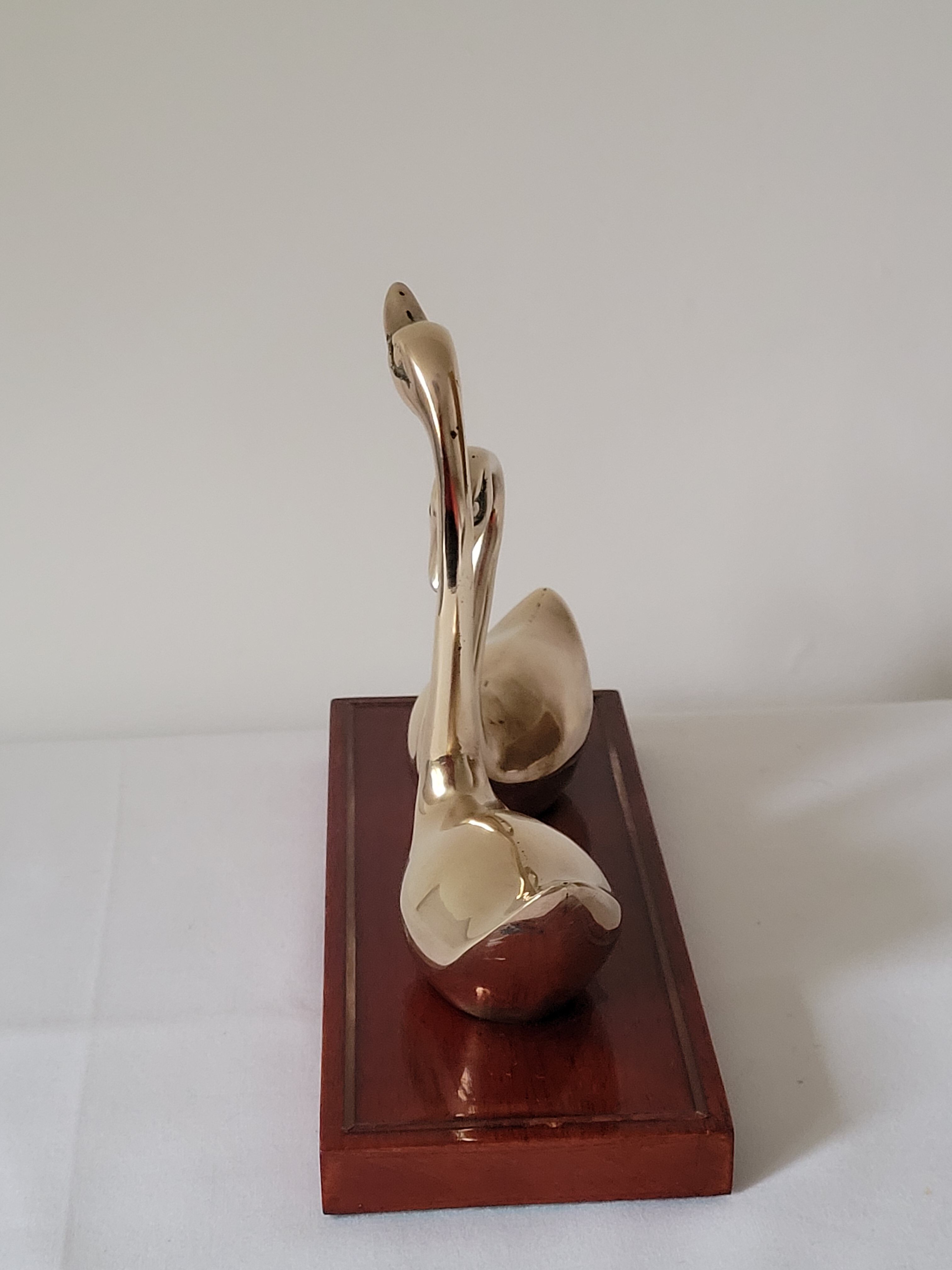 Duo of brass swans on base