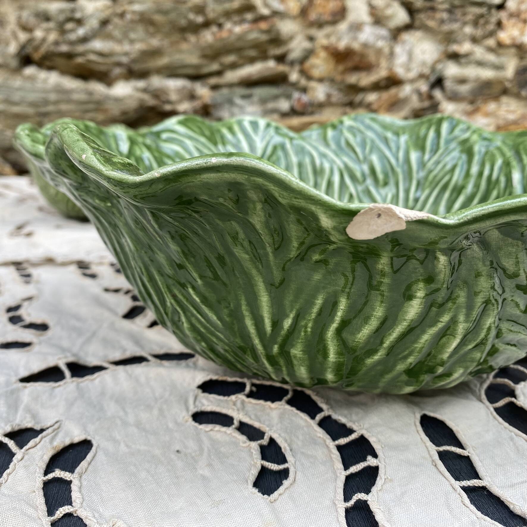 Large earthenware salad bowl in the shape of a cabbage leaf.