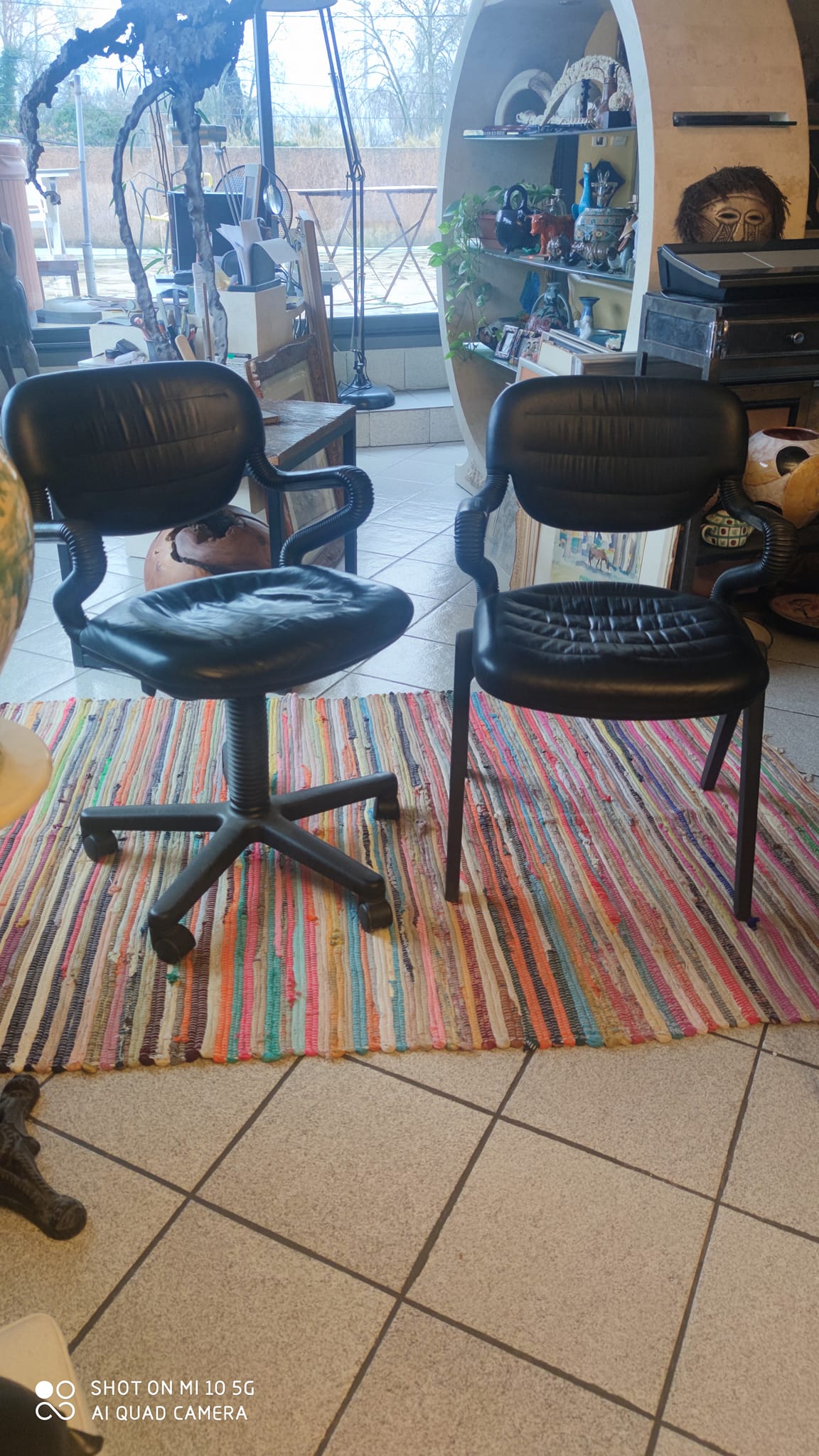 Two black leather armchairs