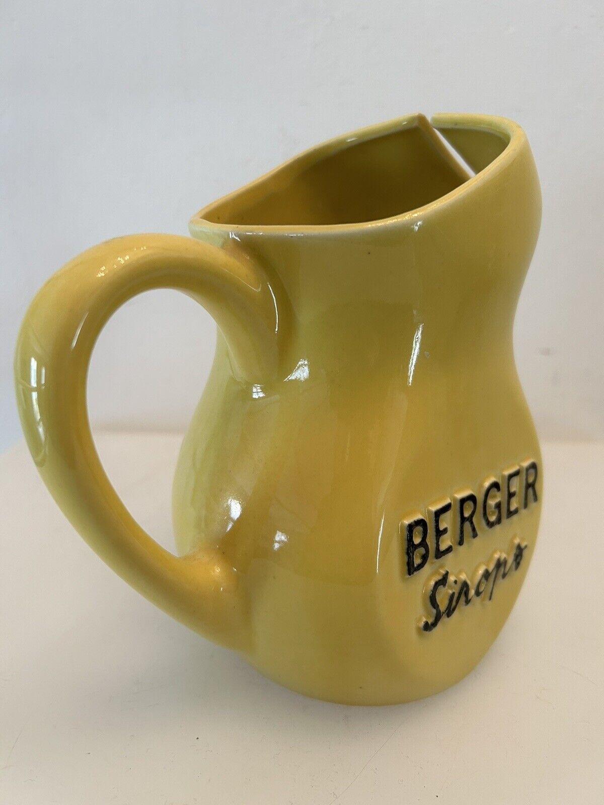 Old yellow pitcher anisette berger syrups, vintage bistro decoration