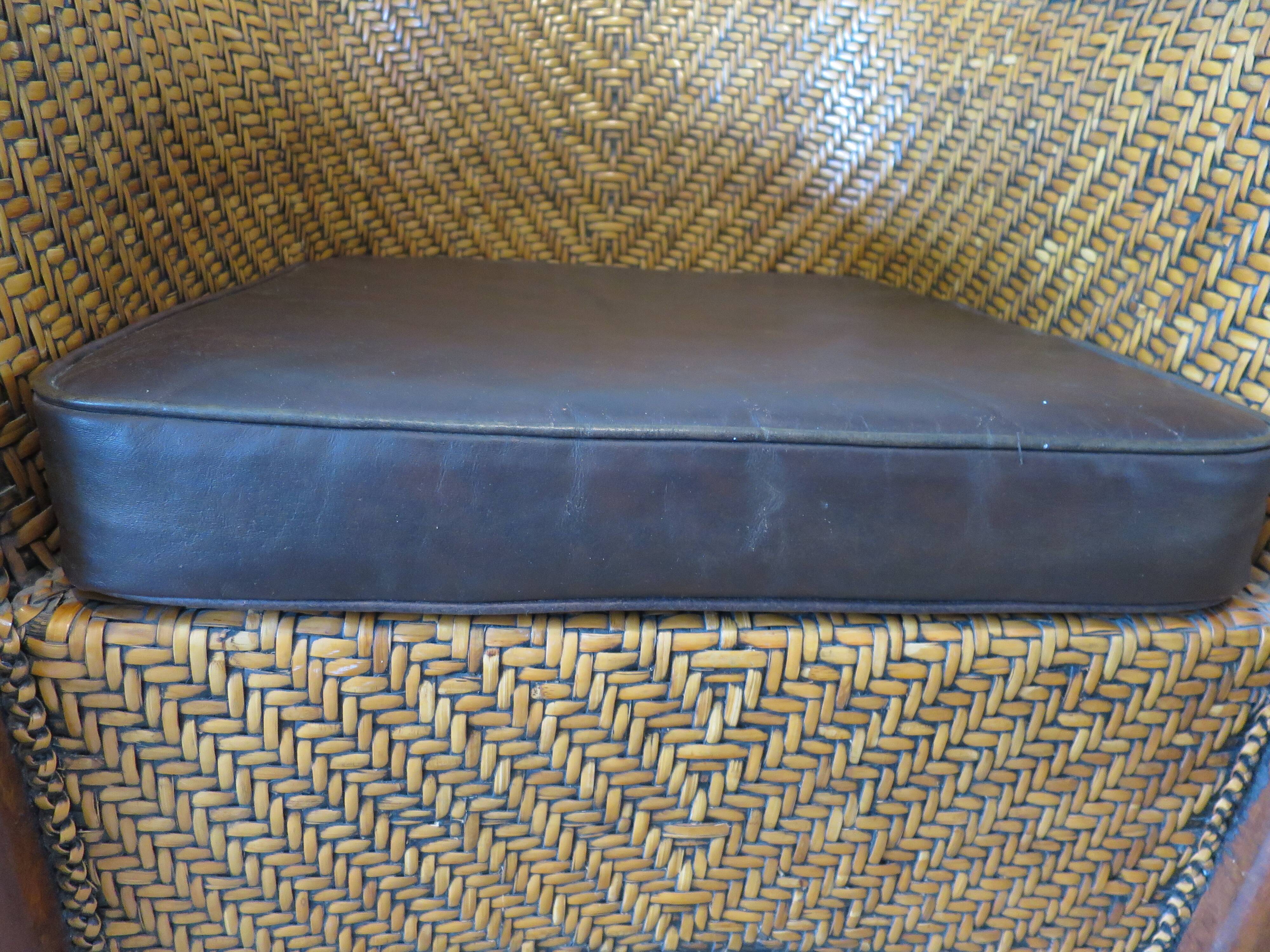Colonial style armchair in woven rattan and exotic wood