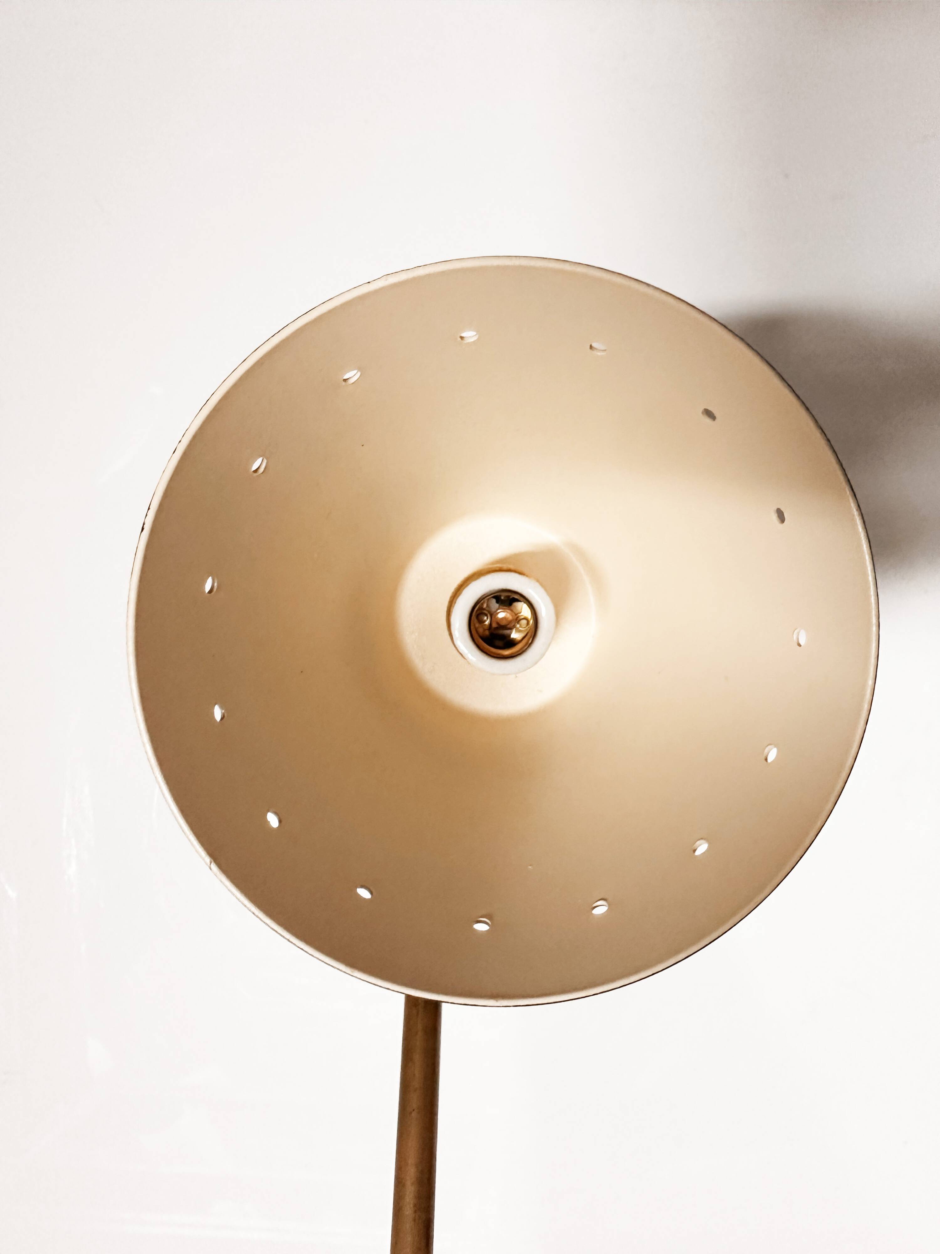 Articulated brass and lacquered iron wall light, 1950s design.