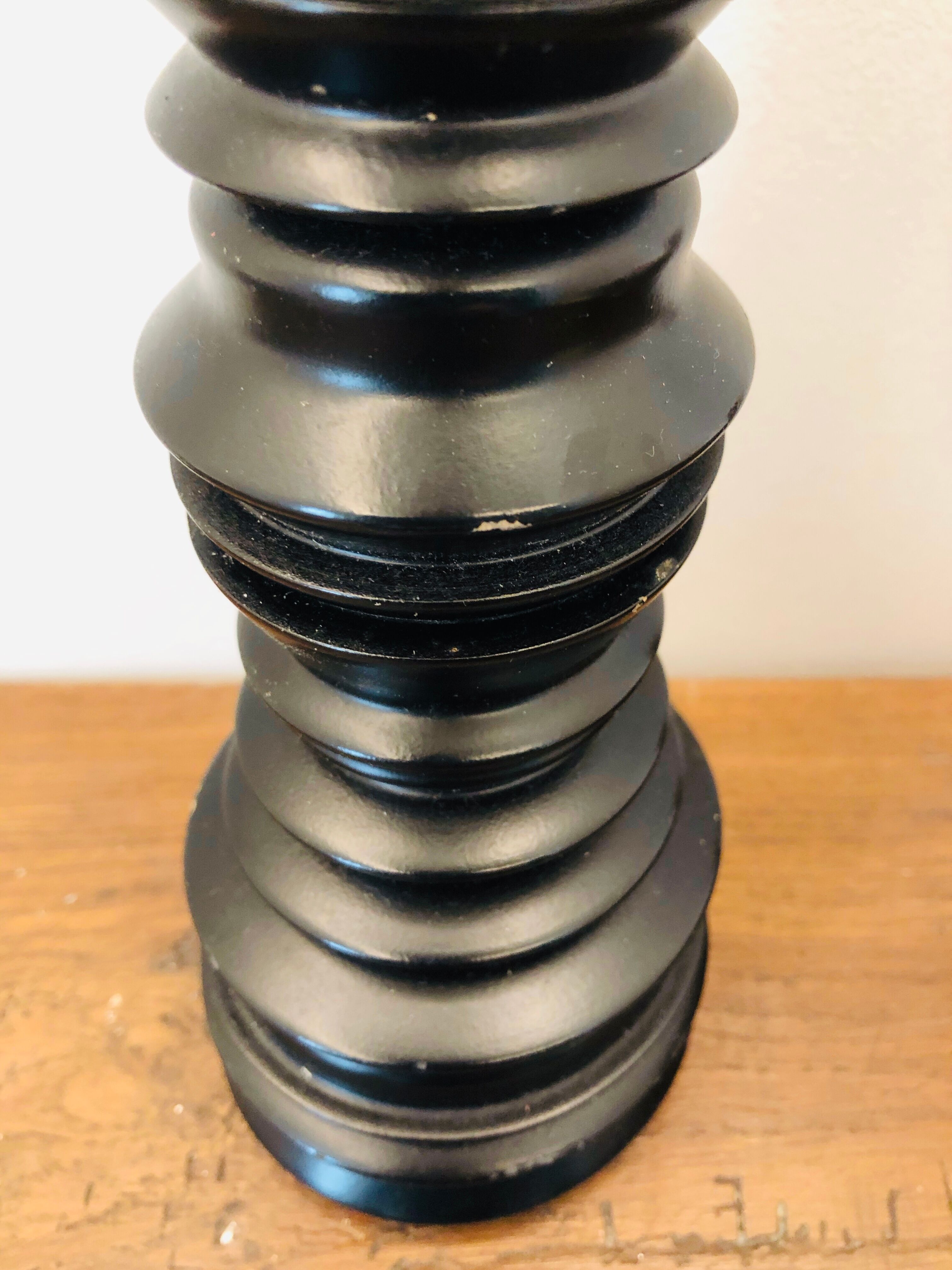 A brutalist black pepper mill