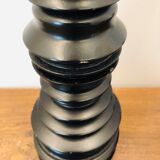 A brutalist black pepper mill